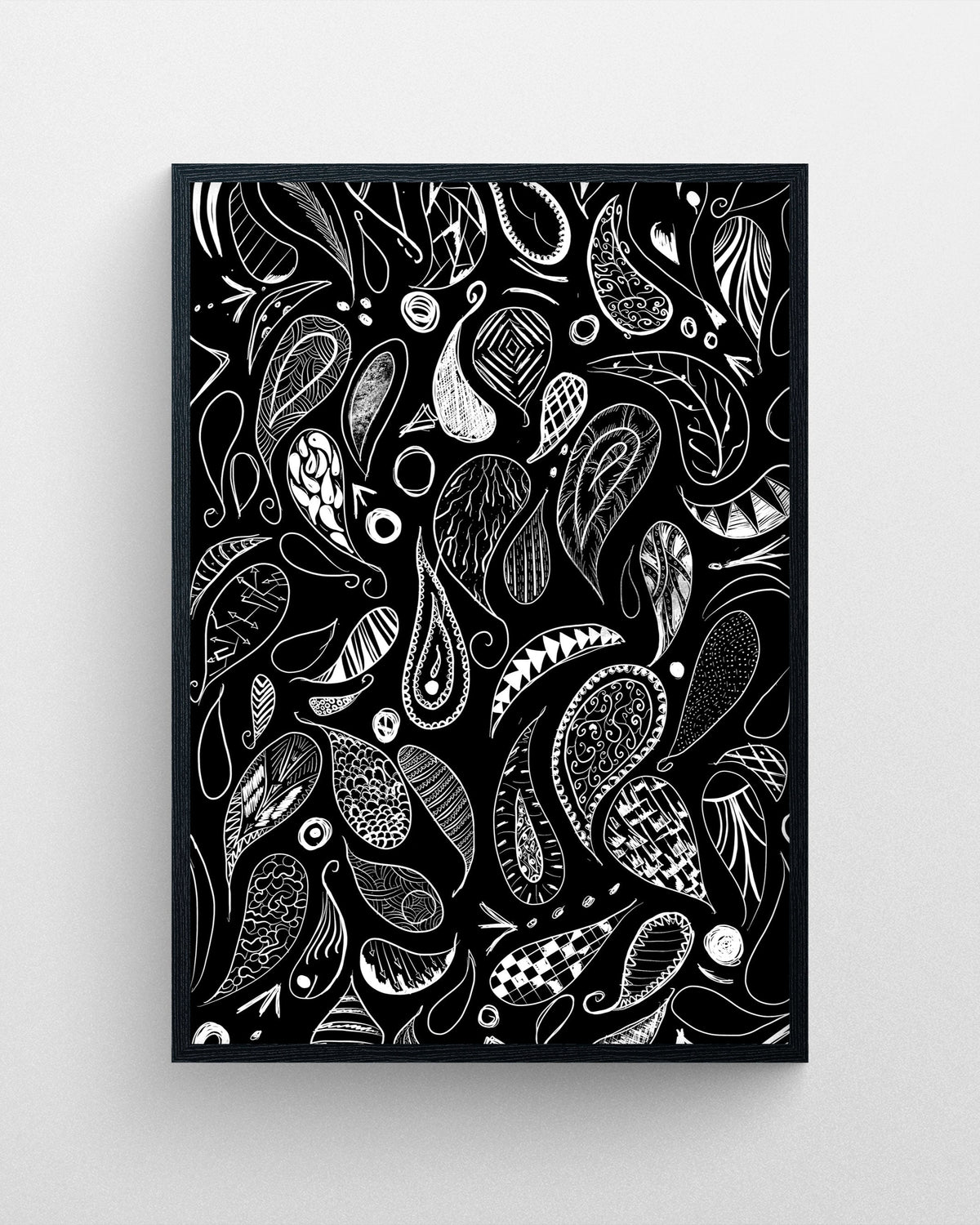 Paisley black and white ornamental illustration featuring intricate paisley patterns and hand-drawn decorative details in a black frame.